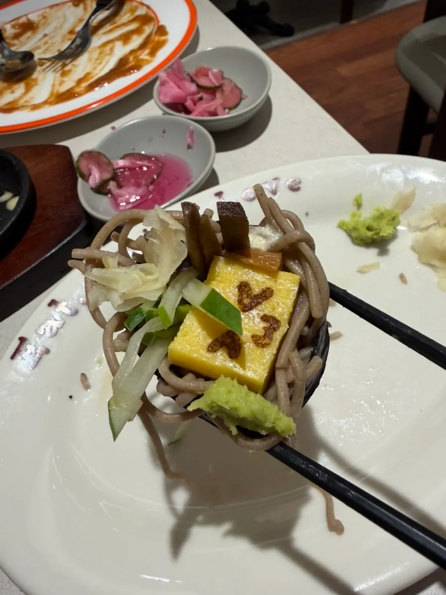 Soba maki lifted up with wasabi on top