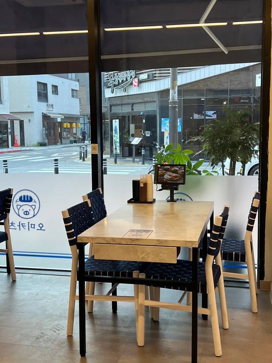 View of tables and kitchen at Omi Katsu