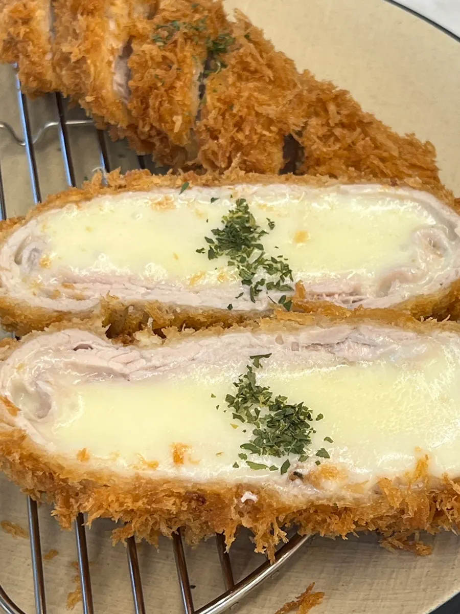 Cross-section of Omi Katsu's cheese katsu with cheese inside
