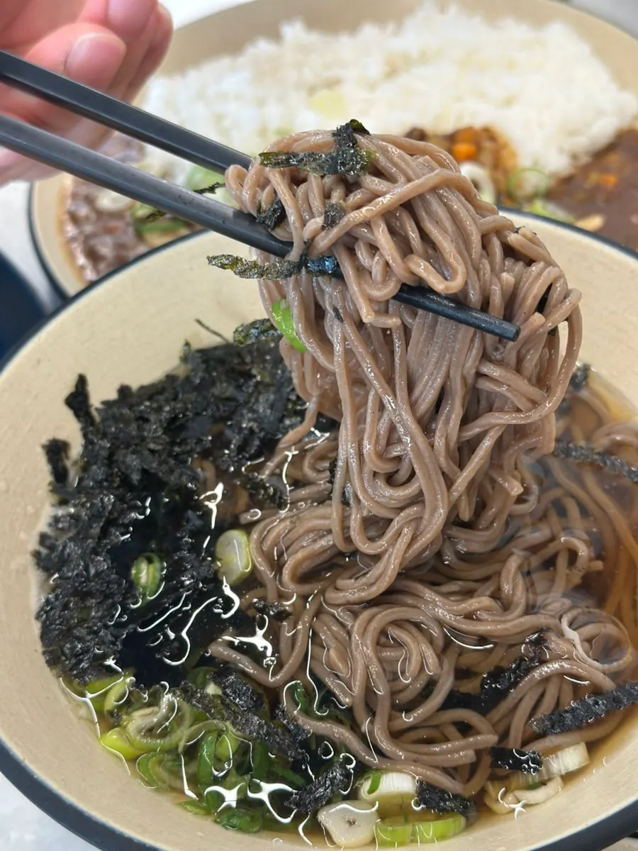 Picking up cold soba noodles with chopsticks