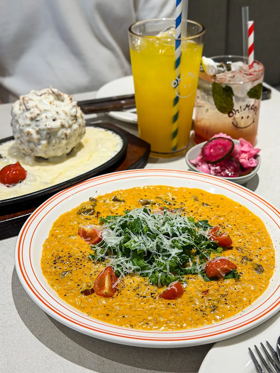 Cheese sauce being poured over the sizzling cheese katsu
