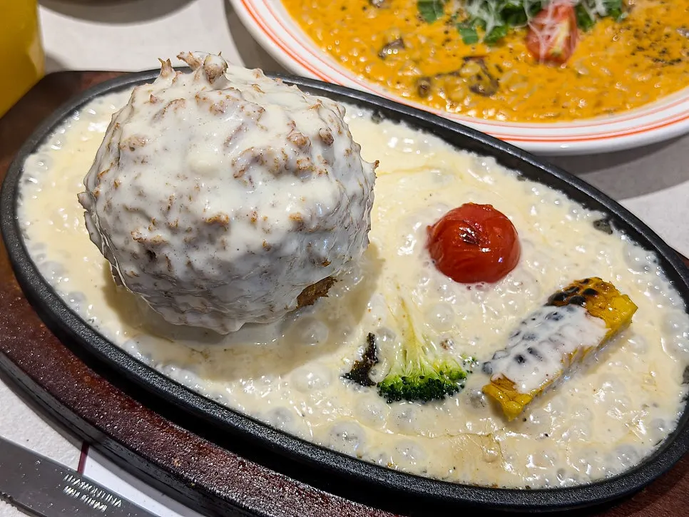 Sizzling cheese katsu served on a hot plate