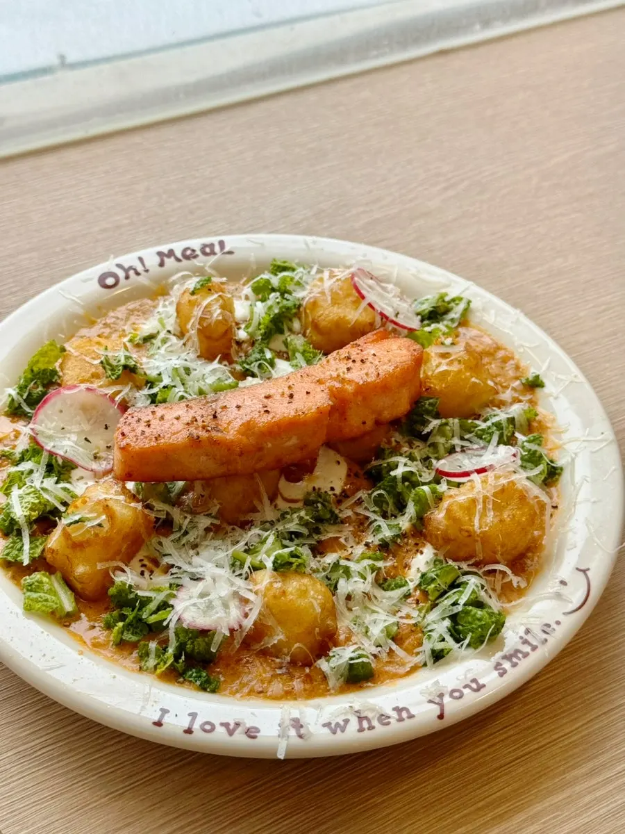 A plate of salmon steak gnocchi