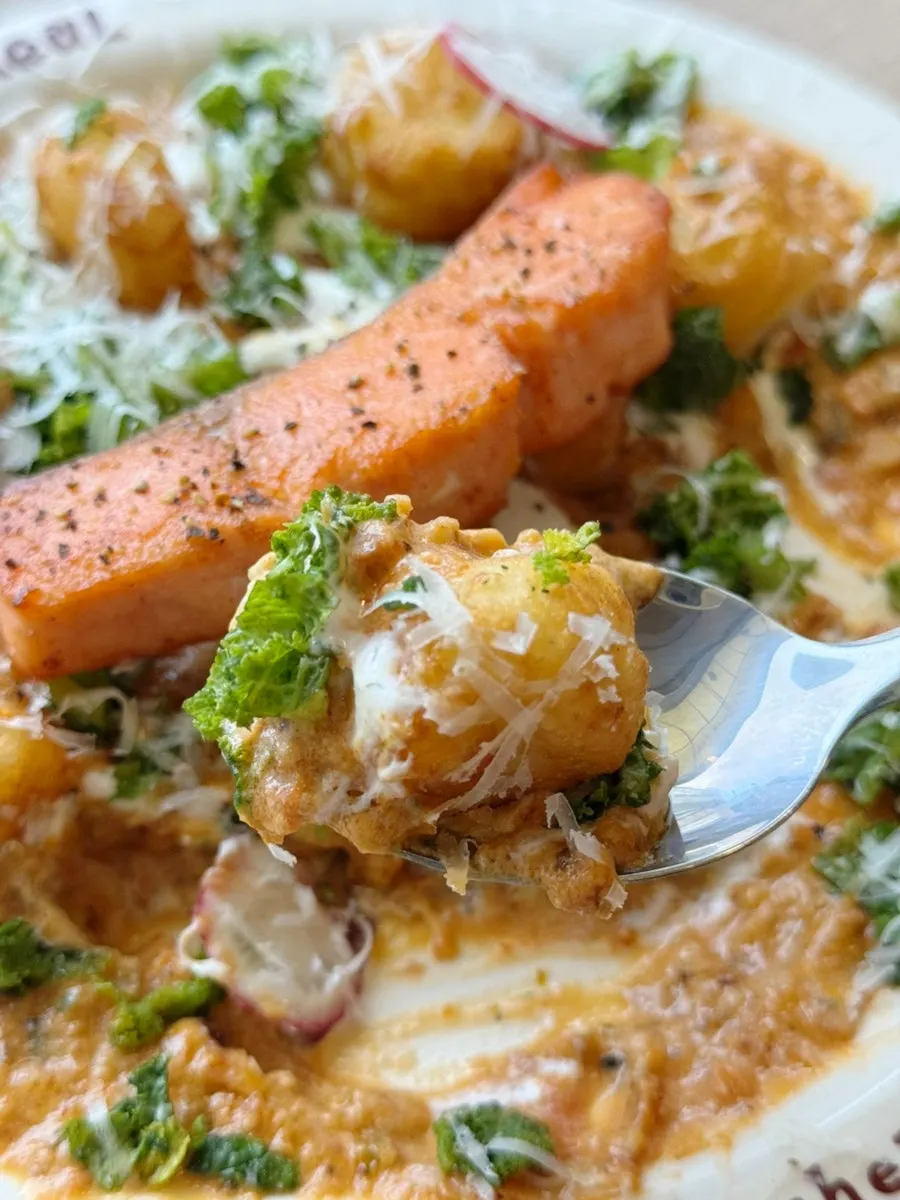 Rosé sauce gnocchi topped with cheese and herbs