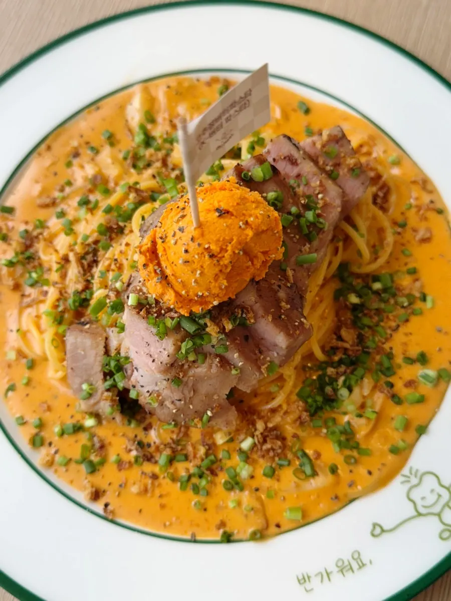 A round dollop of gochujang butter on top of the pasta