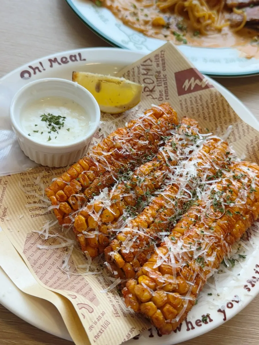 Corn fritters topped with Padano cheese