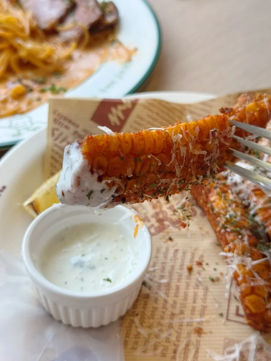 Eating the corn fritters by hand