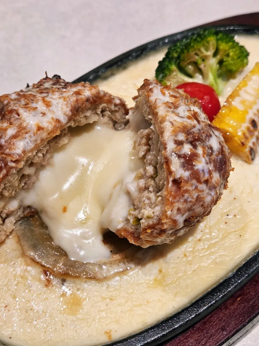 Cutting the cheese katsu in half with a knife