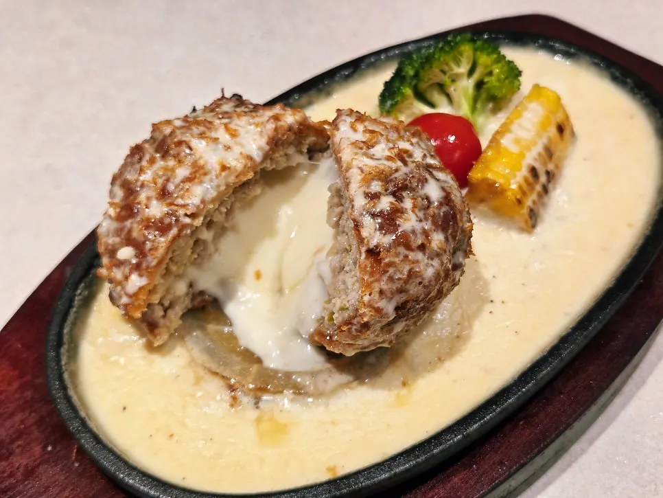 The cheese katsu cut open on the plate