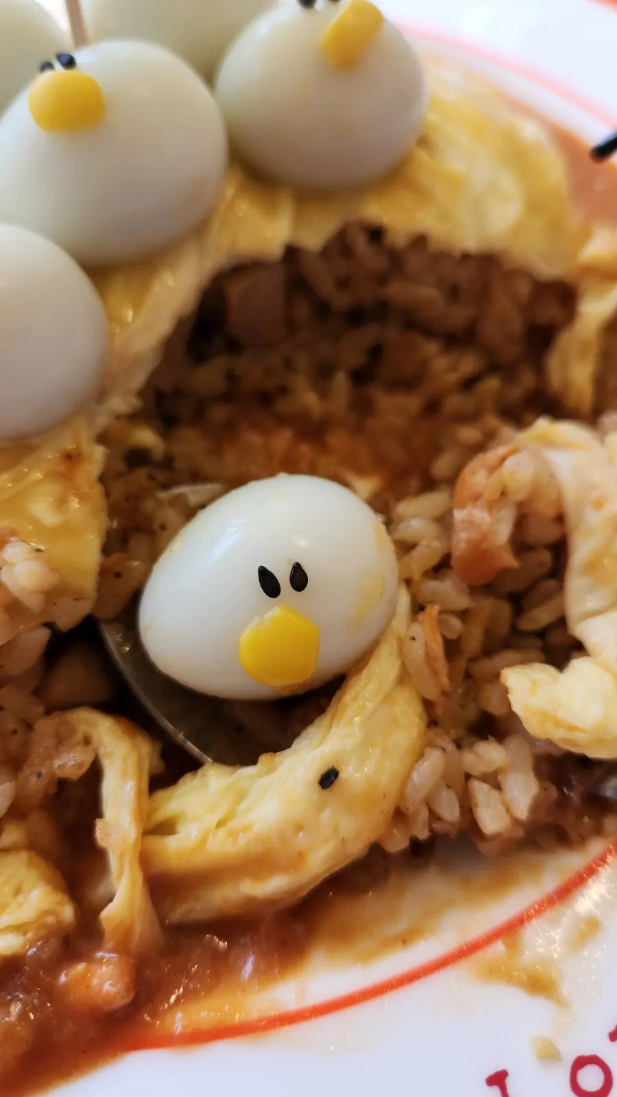 Egg sheet split open to reveal fried rice inside the omurice