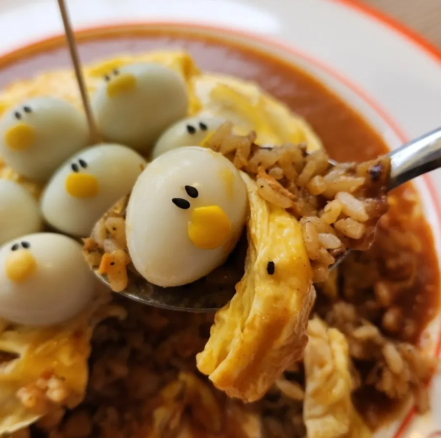 A spoonful of omurice with sauce