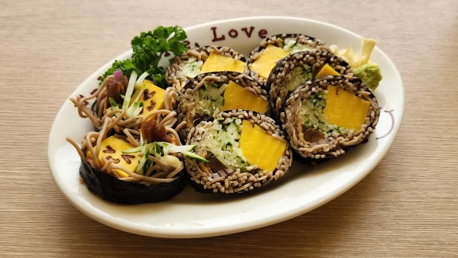 A plate of buckwheat soba maki rolled with buckwheat noodles