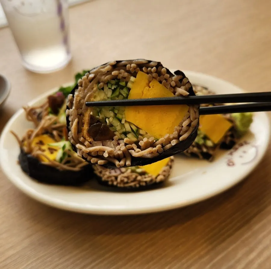 Cross-section of soba maki showing rolled omelet and cucumber