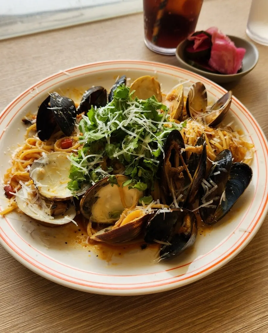 Pasta noodles and seafood coated in oil sauce