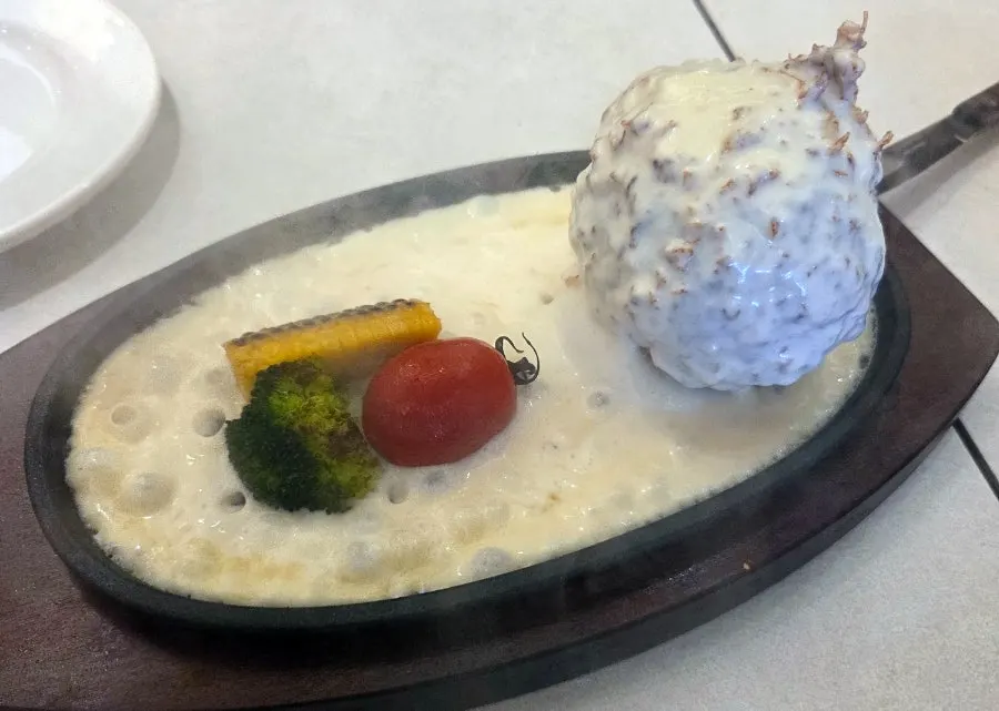 Omil's sizzling cheese katsu served on a hot griddle