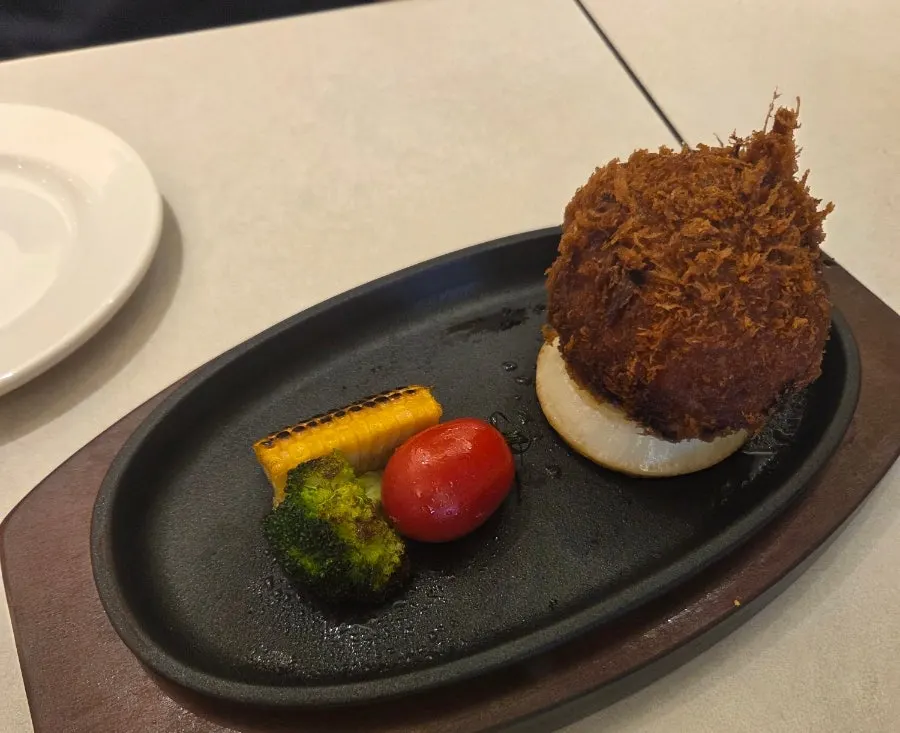 Sizzling cheese katsu before the cheese is poured on
