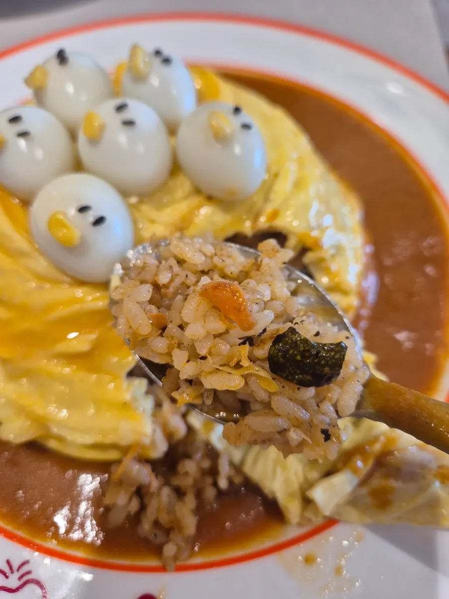 Cross-section of the rubber duck omurice showing salmon fried rice