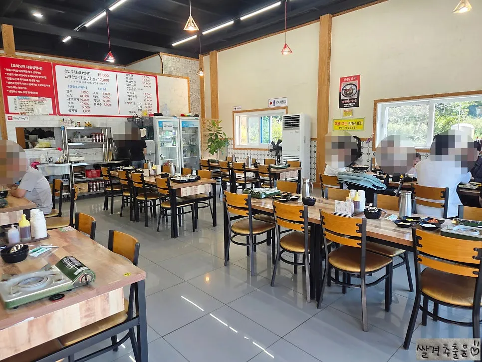 Table seating and menu board at Omi Omi
