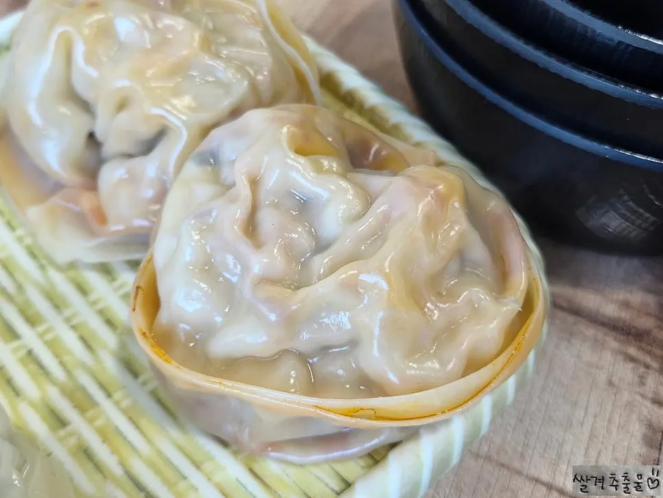 Large steamed dumplings in a steamer basket