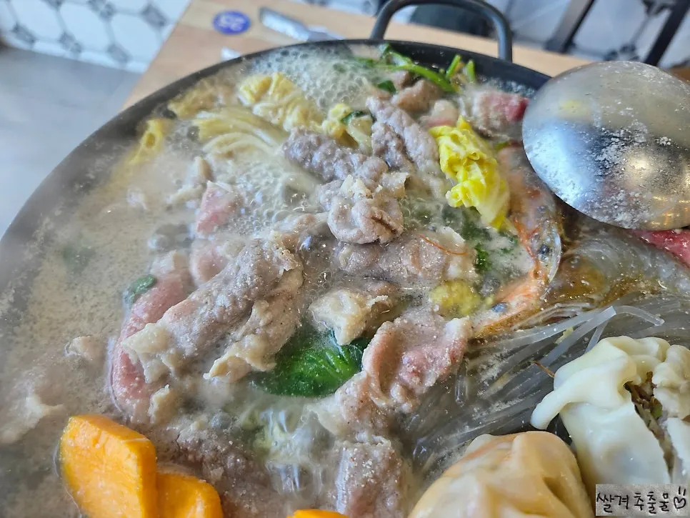 Meat and dumplings lifted out of the hot pot