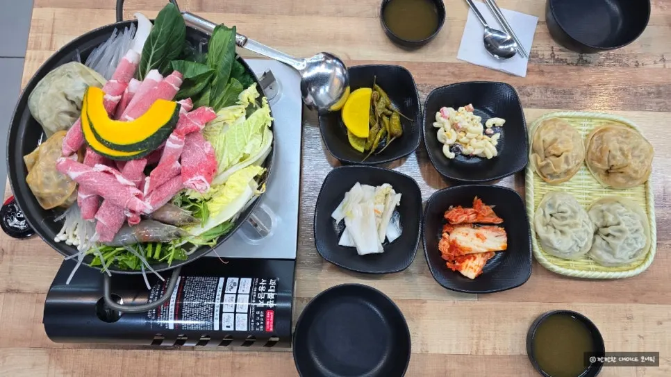 Dumpling hot pot pot filled with king dumplings, beef, shrimp, and vegetables