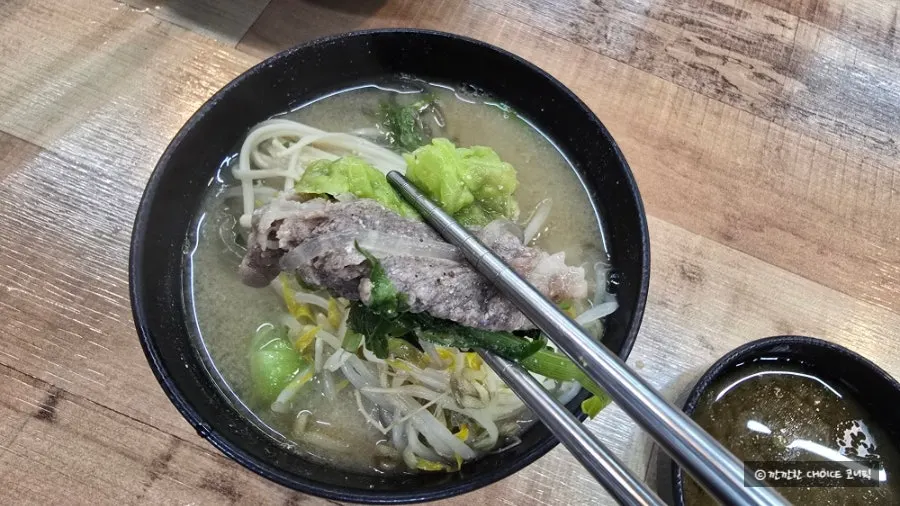 King dumpling lifted out soaked in hot pot broth