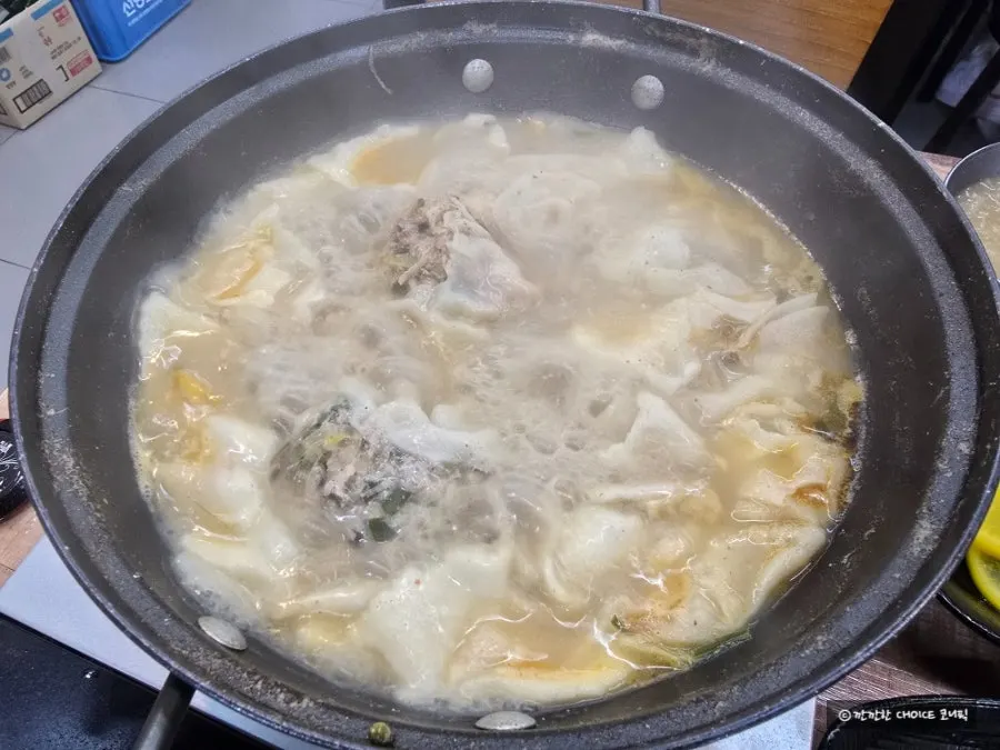 Spoonful of sujebi soaked in broth