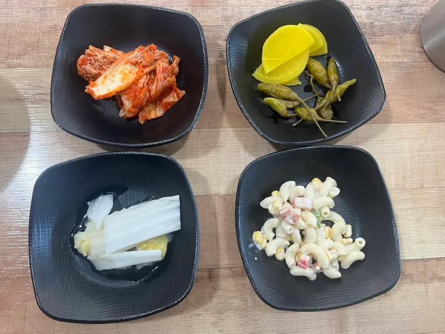 Table setting with a huge handmade dumpling and side dishes