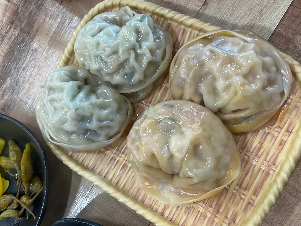Full table setting for two servings of handmade dumpling hot pot