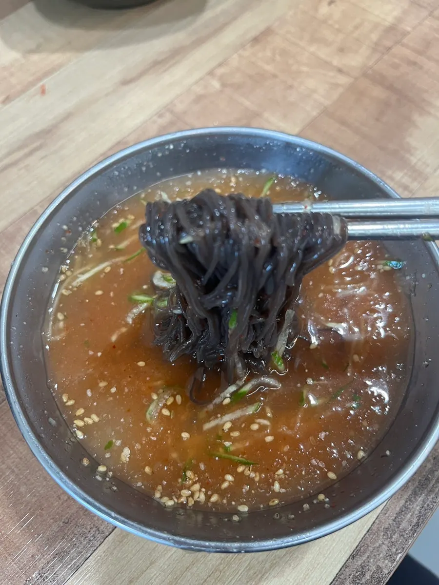 Sujebi noodles added into the hot pot broth