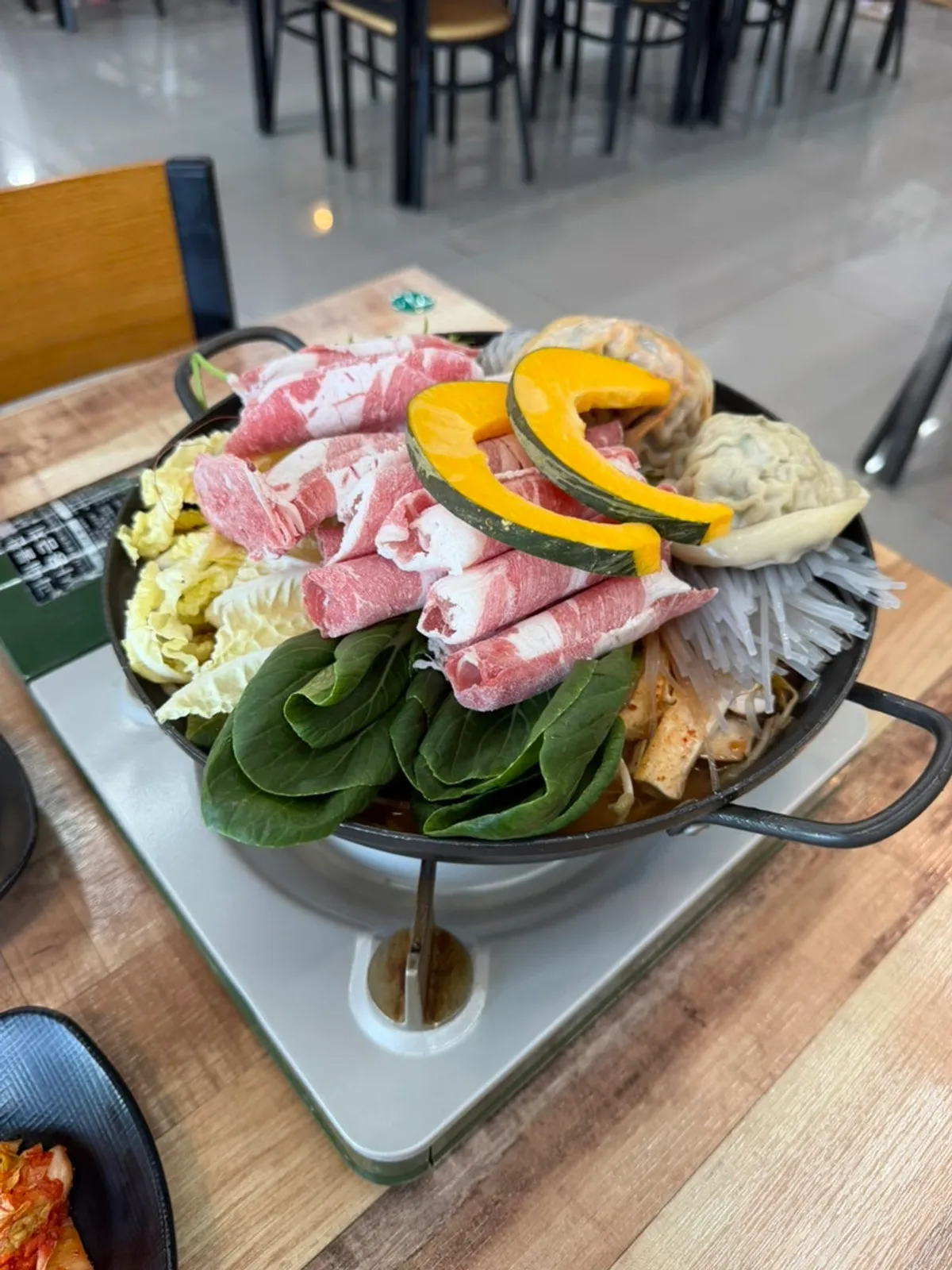 A generous serving of spicy handmade dumpling hot pot for two