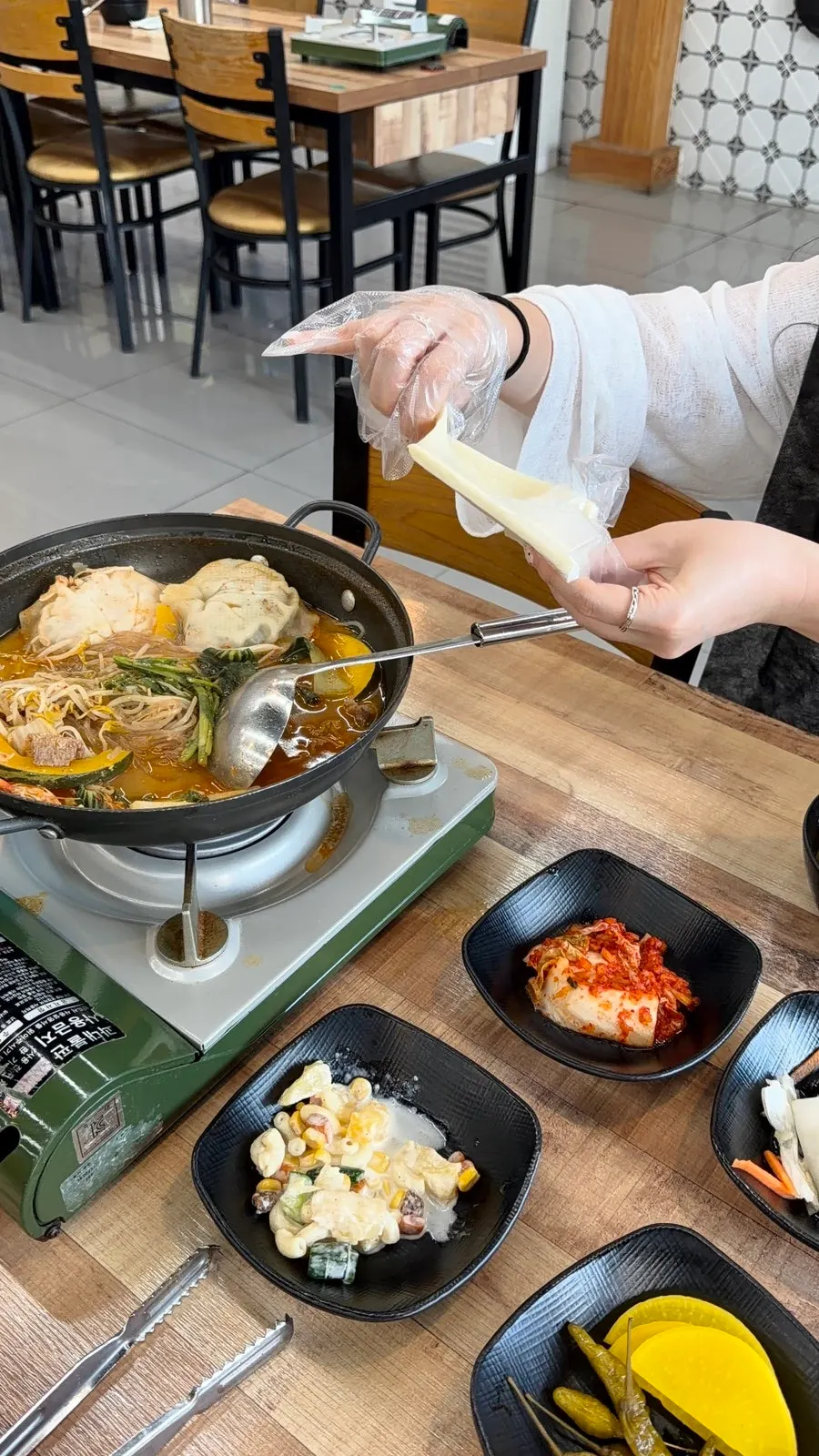 A ladleful of spicy dumpling hot pot broth