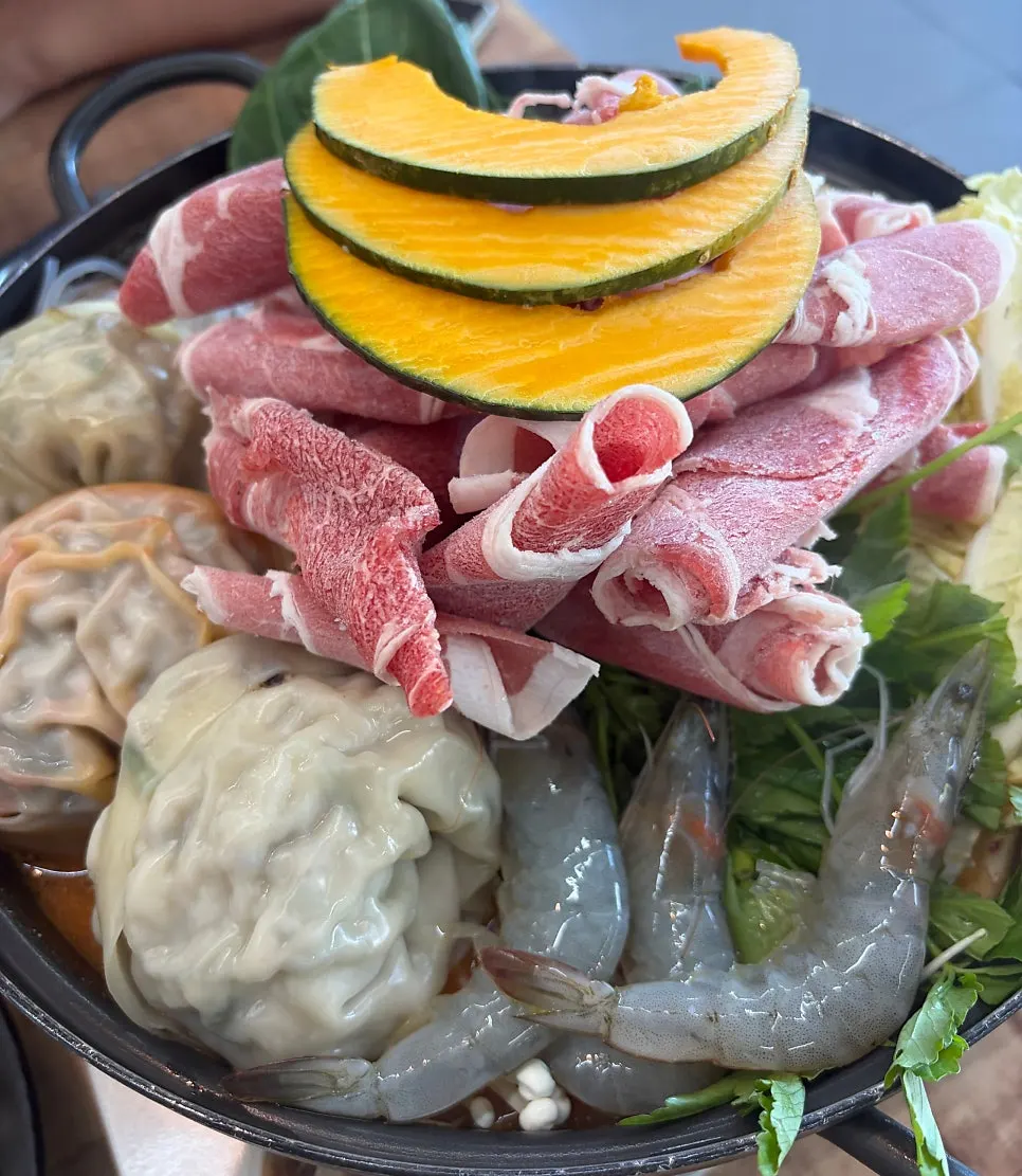 Dumpling hot pot topped with shrimp and brisket