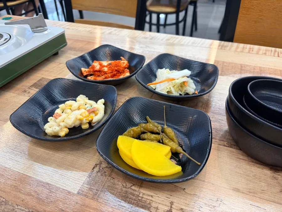 Basic side dishes: kimchi, salad, pickled radish, baek-kimchi