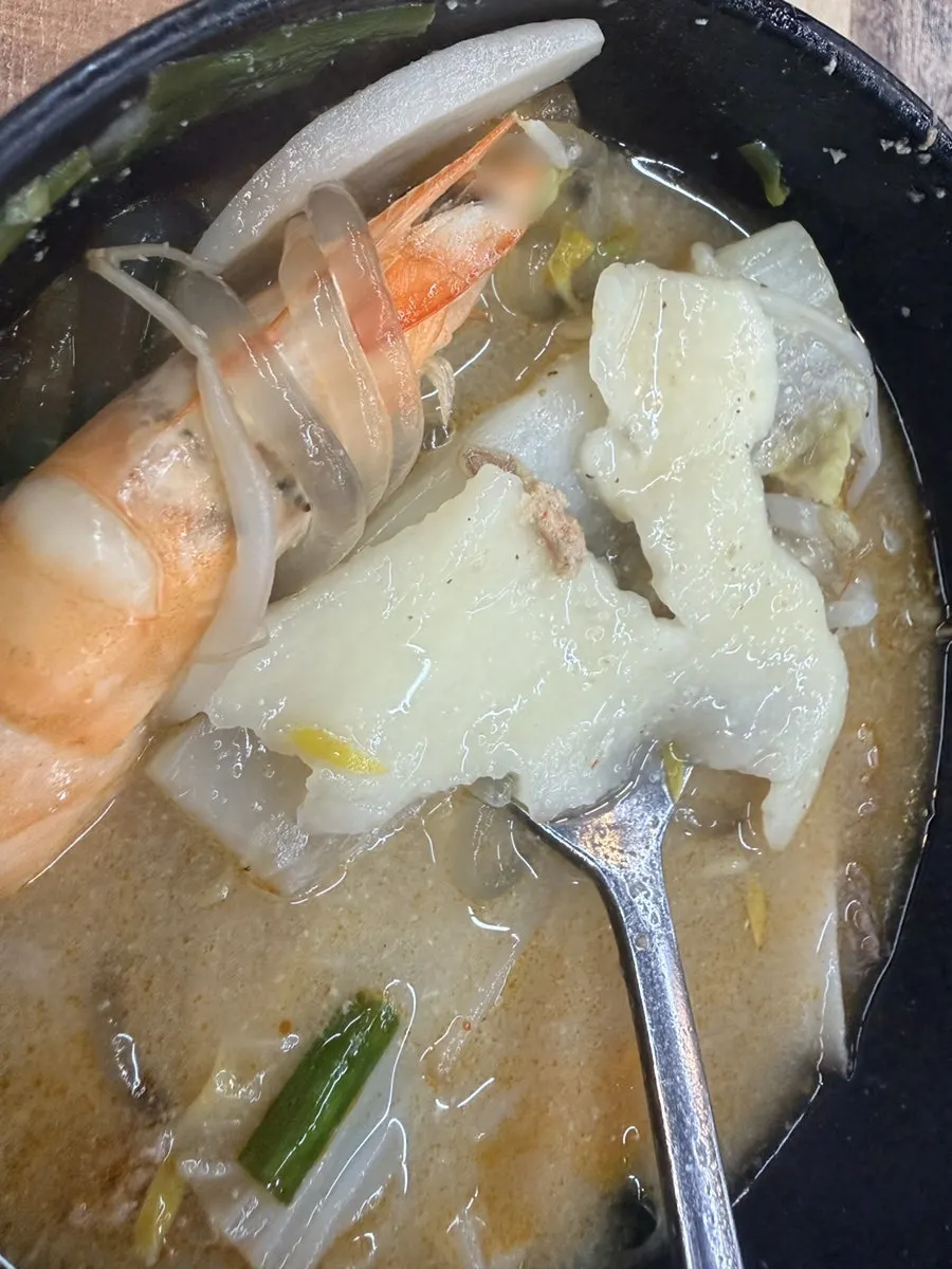A bowl of broth with chewy sujebi