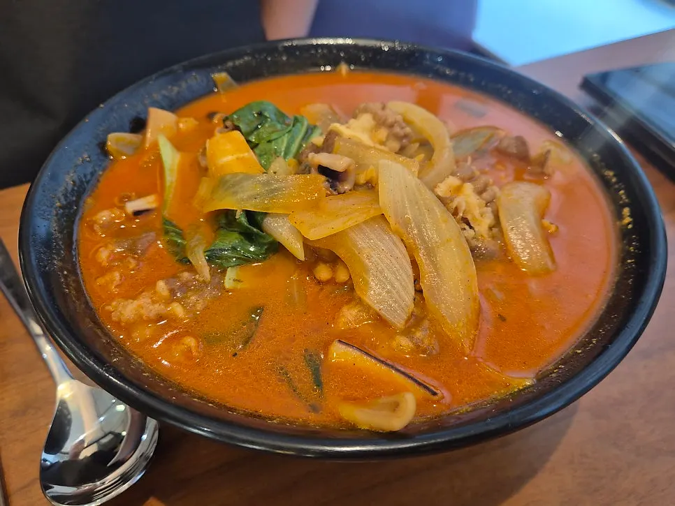Spicy chili jjampong topped with chili powder and peppers