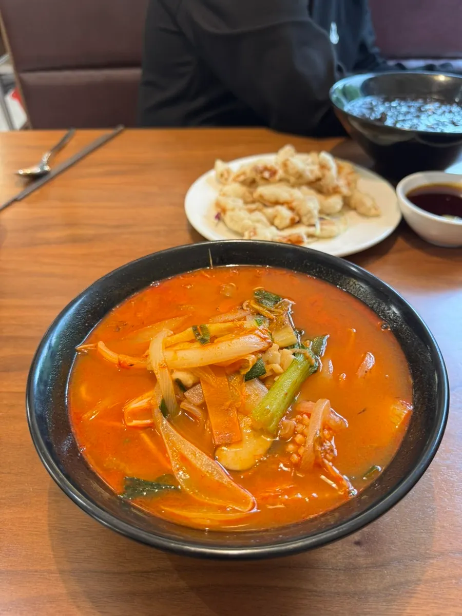 Chili powder on the table next to the jjajangmyeon