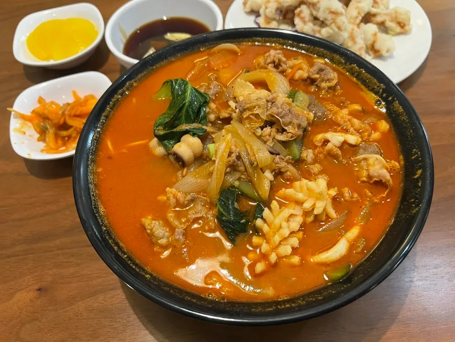A bowl of the bone-broth based seafood jjampong