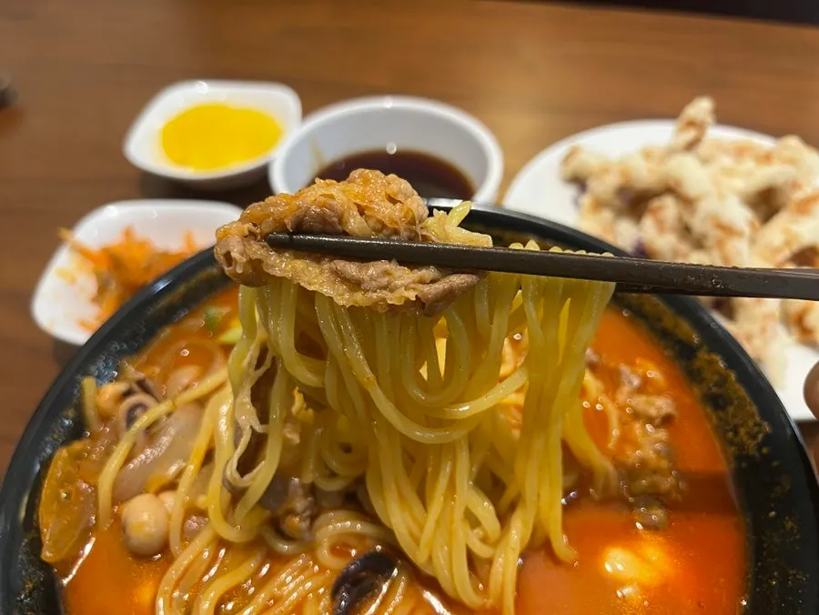 Jjampong toppings coming up tangled with the noodles
