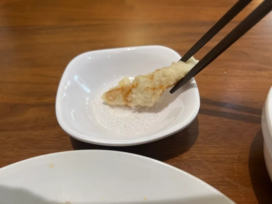 A piece of tangsuyuk dipped in table salt