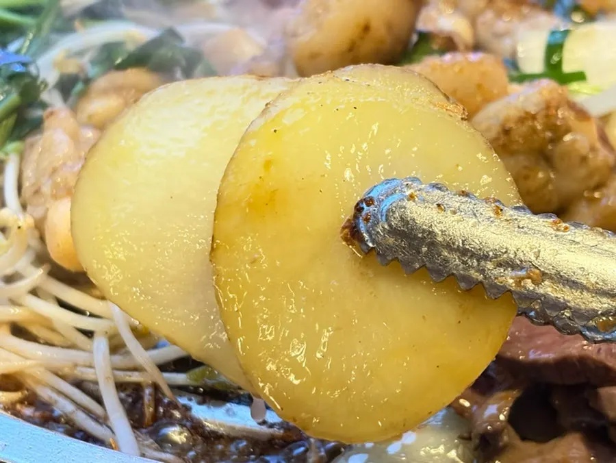 Potatoes and gopchang grilling together on the grill