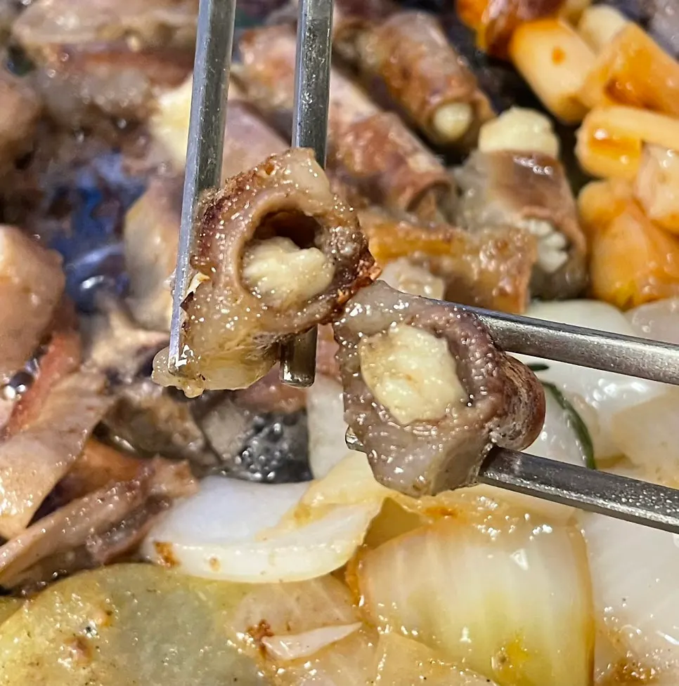 불판 위에서 구워지는 곱창과 대파김치