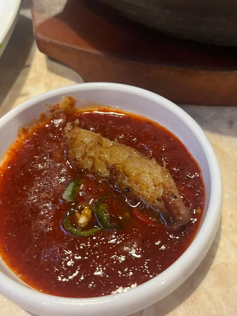 Traditional handmade garlic gopchang with scallion kimchi