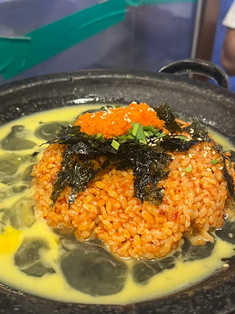 Fried rice being stir-fried on the grill