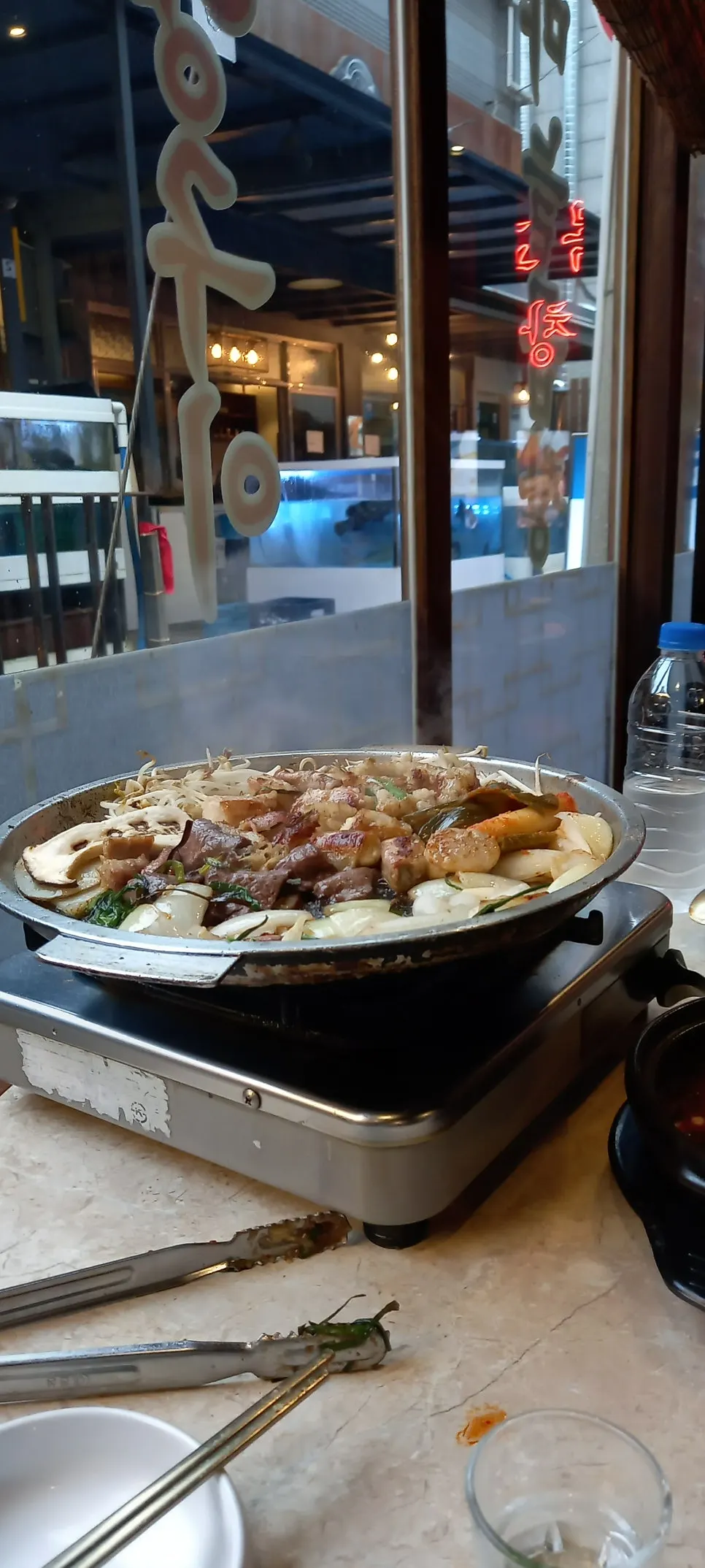 Table with grilled meat, stew and side dishes all laid out together