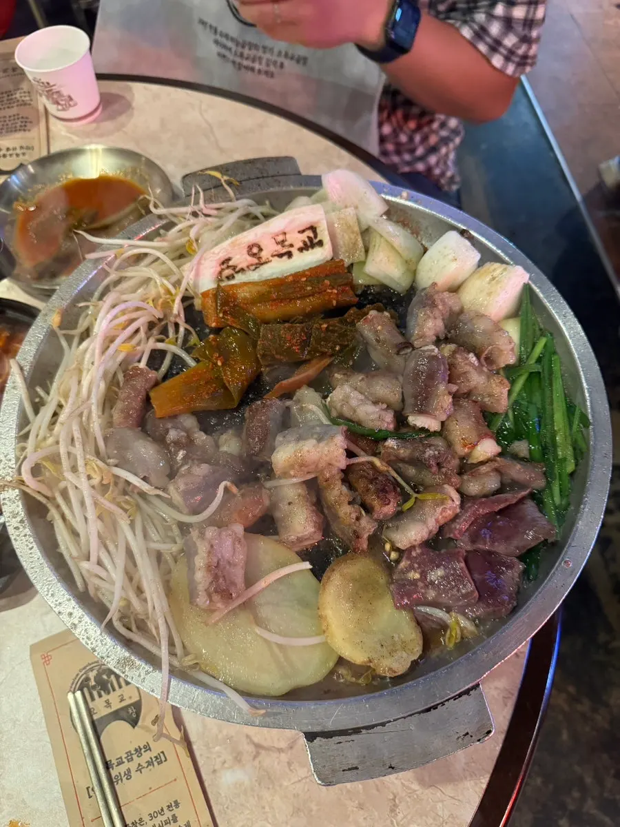 Garlic gopchang being grilled tableside with a fire show