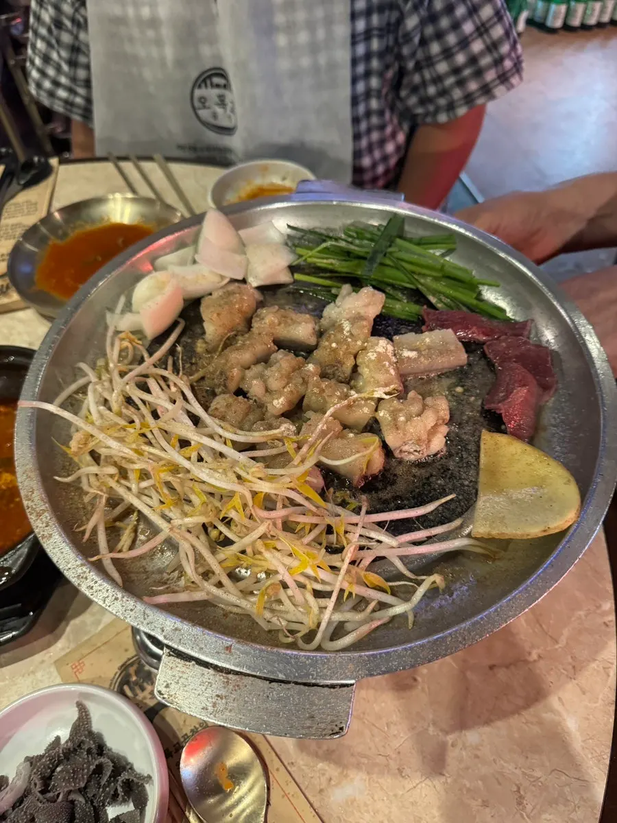 A full spread of bibim guksu and grilled gopchang