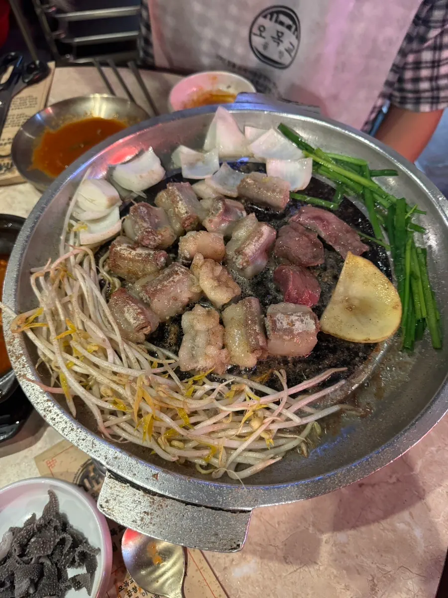 A visitor looking satisfied while eating gopchang