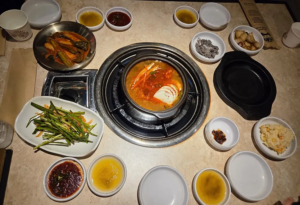 Table set with side dishes and complimentary sundubu-jjigae