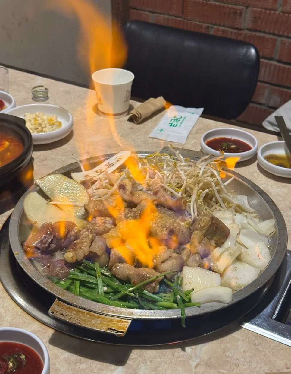 Garlic gopchang on the griddle engulfed in the fire show